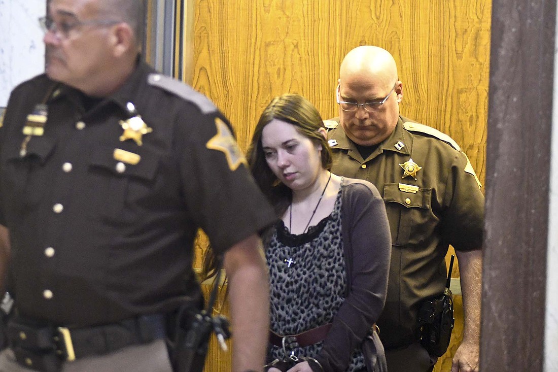 Chelsea Crossland of Portland is led out of the elevator at Jay County Courthouse by Jay County Sheriff Ray Newton, with Patrick Wells of the sheriffÕs office following. Crossland was found guilty Thursday at the conclusion of a four-day trial of murdering her 5-year-old son. The jury subsequently voted to sentence her to life in prison without parole. (The Commercial Review/Andrew Balko)