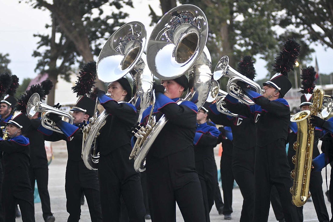 Sousaphone players Trenton Hamilton and Chance Sturgill lead a group of Jay County High School Marching Patriots across the track near the end of their performance Friday during the Jay County Lions Band Contest at the grandstand at Jay County Fairgrounds. The Marching Patriots were runners-up in their first contest of the season, scoring 67.175 points to trail only champion Muncie Central. Richmond was third with 67.075 with Centerville (64.525) fourth and Anderson (64.075) fifth. (The Commercial Review/Ray Cooney)