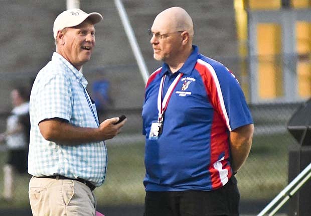 Former Jay County High School band director Kelly Smeltzer chats with his successor Chuck Roesch on Saturday night prior to the Marching Patriots taking the field for the Muncie Spirit of Sound contest at Southside Middle School. Smeltzer was volunteering at the event, keeping time and leading bands on and off the field. (The Commercial Review/Ray Cooney)