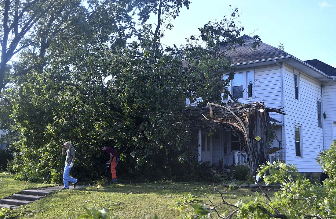 A tree that came down between 3 and 3:30 a.m. Saturday morning hit the northeast side of the home of Ryan and Kristen Davisson at 403 E. Arch St. in Portland. Another tree landed on their vehicles and garage on the south side of the property. (The Commercial Review/Ray Cooney)