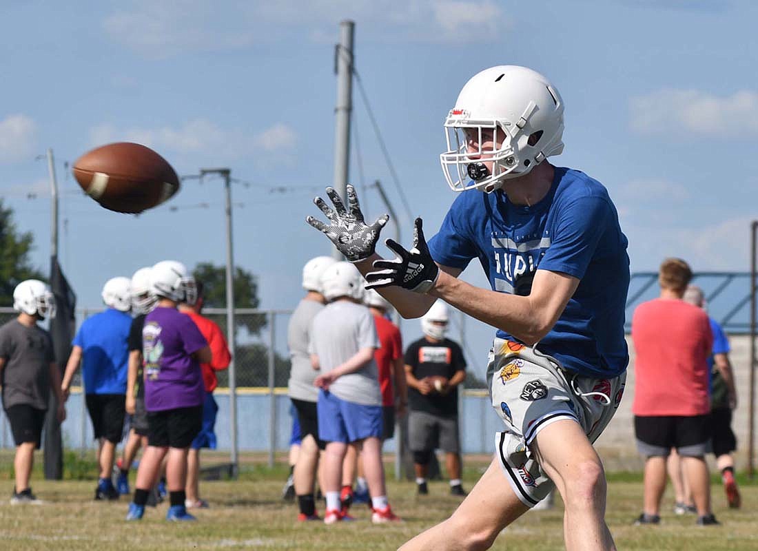 Ben Crouch receives a ball during the Jay County High School football teamÕs practice on Monday afternoon. The Patriots have a scrimmage at Richmond on Aug. 11 before opening their season at home against the Blackford Bruins Aug. 18. (The Commercial Review/Andrew Balko)