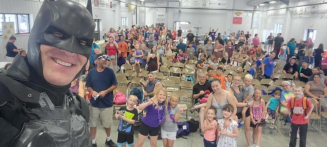 Batman takes a selfie with visitors to the inaugural Jay Community Day hosted by Jay County Fair Board on Saturday. The event focused on getting children ready for the start of school Ñ Jay School Corporation returns to classes Aug. 10 Ñ included distributing about 400 free backpacks and a variety of other school supplies. (Photo provided)