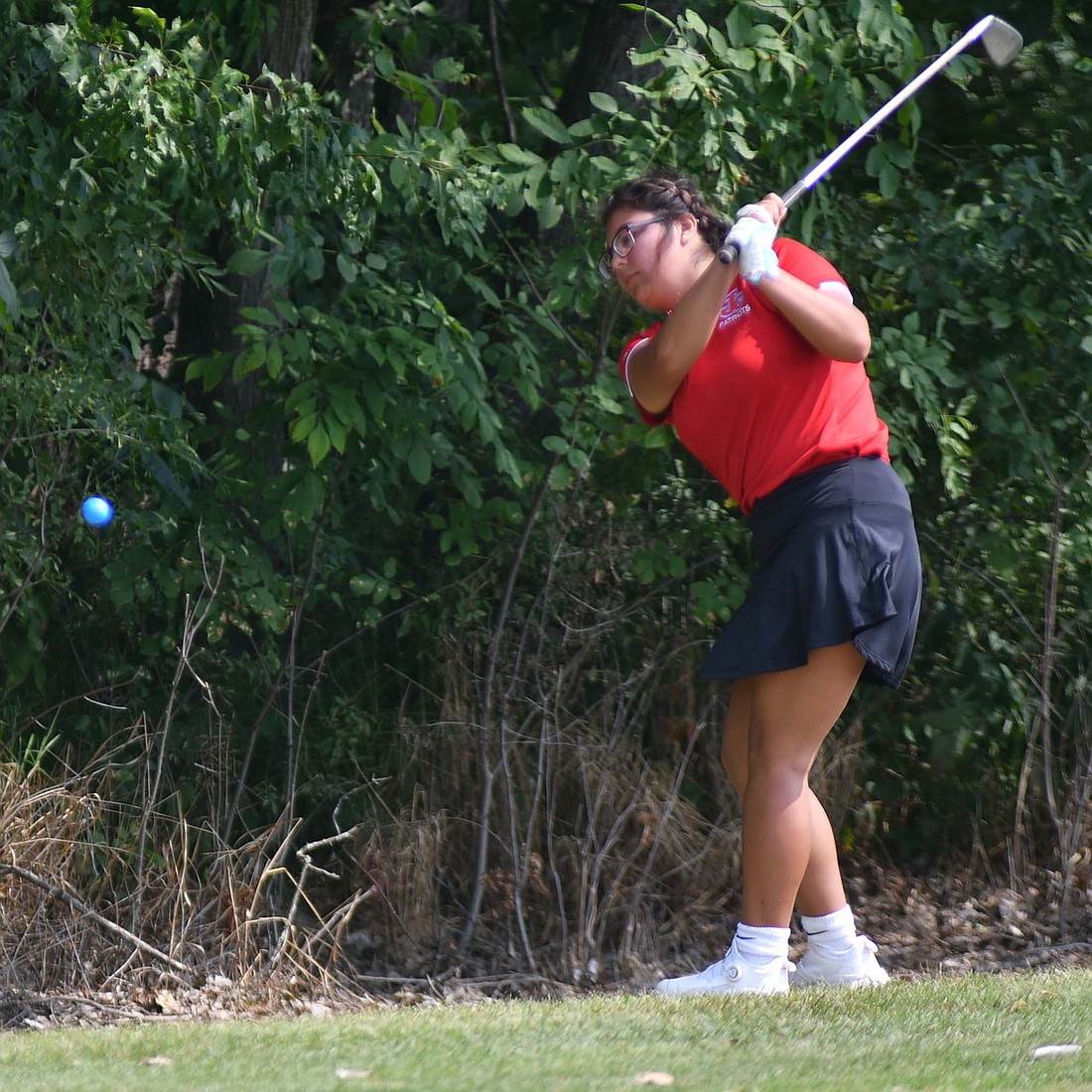 .JCHS sophomore Meah Devoe hits her iron on the 350-yard, par 4 hole No. 14 at Wabash Valley Golf Club during the South Adams Invitational on Wednesday. The shot put Devoe on the green and she proceeded to sink a 15-foot putt en route to a 118 as the Patriots placed 10th out of 11 teams. (The Commercial Review/Andrew Balko)