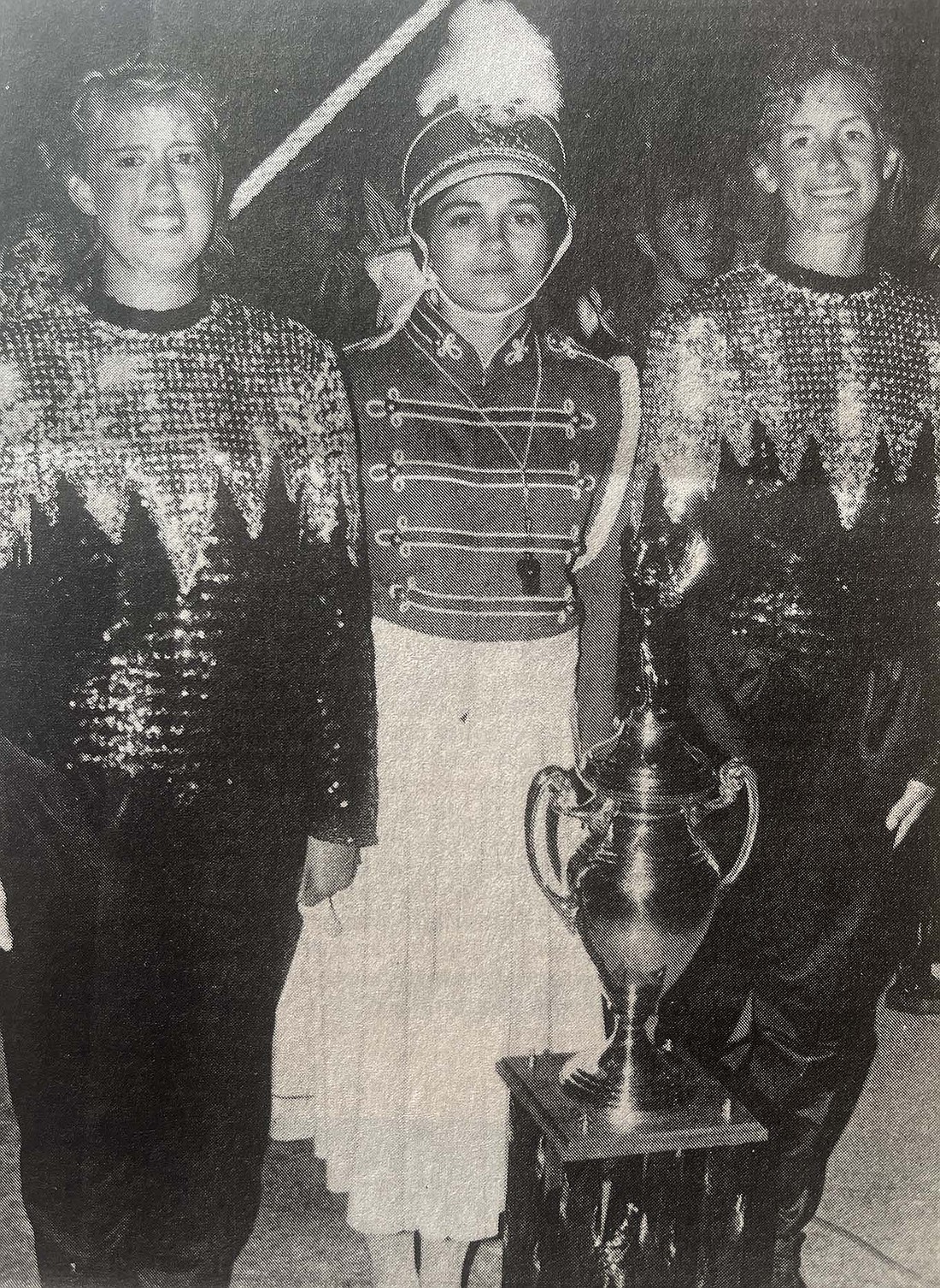 Jay County High School Marching Patriots guard captains Brenda Locker (left) and Lisa Butcher (right) flank drum major Laurie Miller as they pose with their second-place trophy at the Indiana State Fair on Aug. 12, 1993. (The Commercial Review/Jack Ronald)