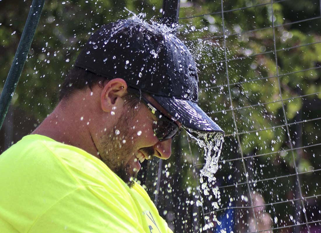 Isaiah Rogers gets soaked after a festival-goer hits the target on a dunk tank at Redkey Gas Boom Days on Saturday. The festival held Saturday and Sunday featured a parade, food, various performers, a cornhole tournament and vendors. (The Commercial Review/Bailey Cline)