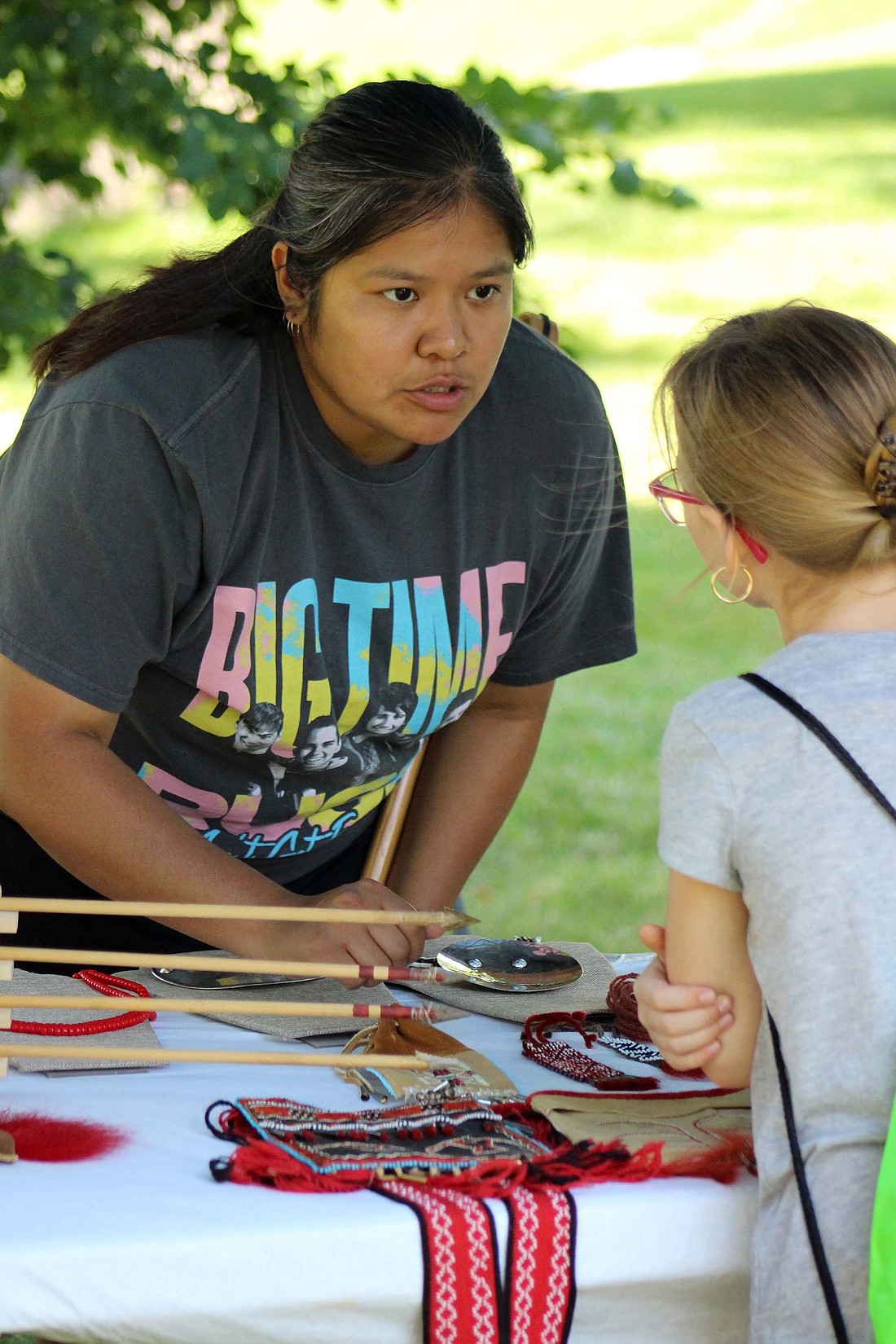 Shelly Silverhorn speaks with a visitor to Fort Recovery State Museum and the surrounding area Saturday. She and her husband, Talon Silverhorn, and other members of Native American tribes set up stands outside the museum along the walking path during the ÒBeyond the Battlefield: Interpreting St. ClairÕs Defeat through the Eyes of Tribal CitizensÓ interactive event. (The Commercial Review/Bailey Cline)