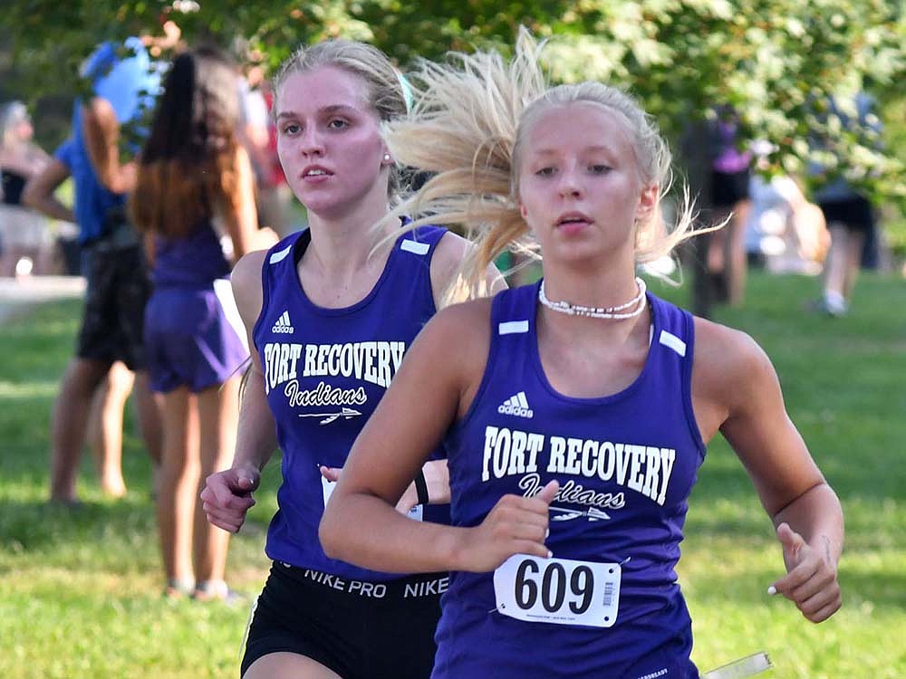 Fort Recovery High Schools Natalie Brunswick (left) and Makenna Huelskamp (right) lead during the Mercer County Cross Country Meet at Ohio Progressive Sportsman Club on Tuesday. The pair of FRHS runners finished first and second in the meet to lead the girls toa county victory. (The Commercial Review/Andrew Balko)