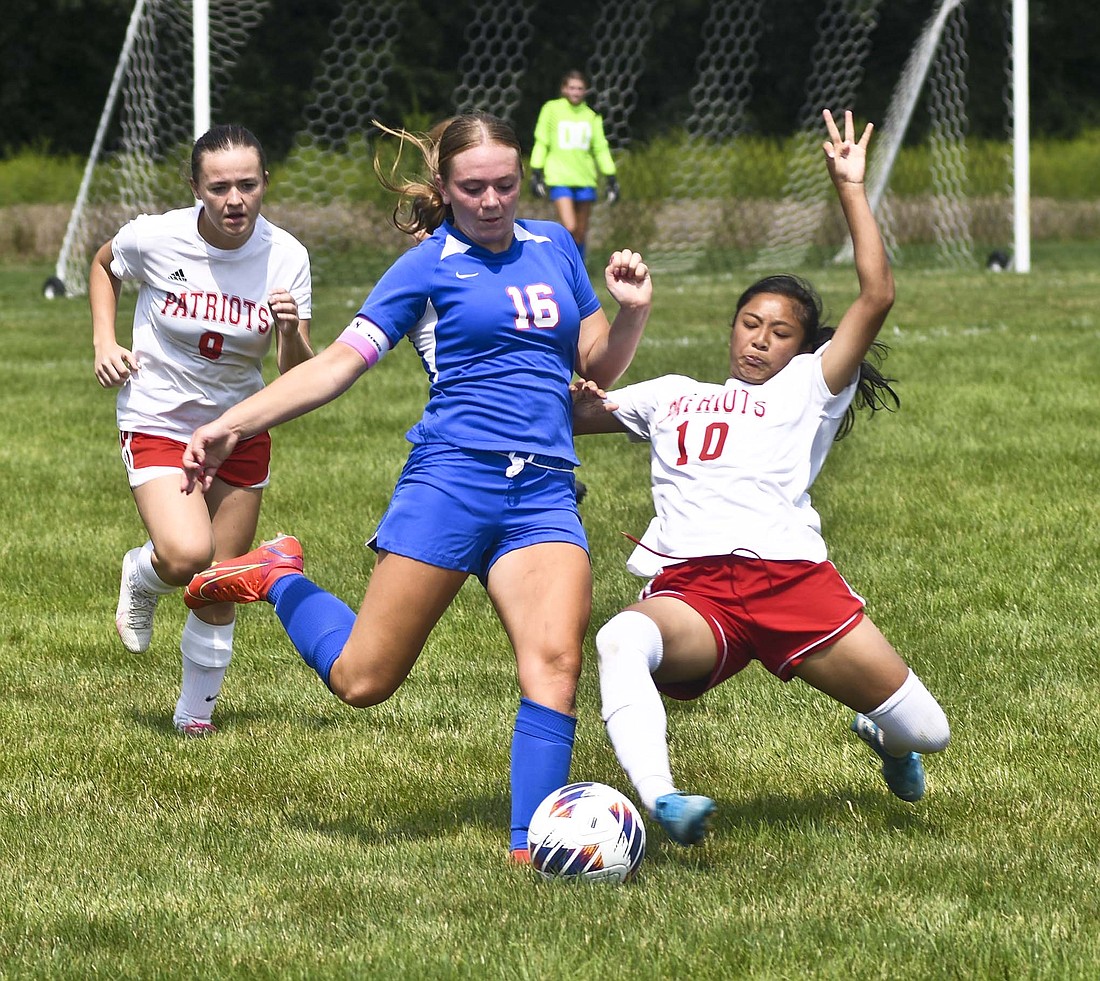 Jay County's Morgan DeHoff (left) tries to send the ball down the field late in the first half while Nin Way of Heritage attempts to knock it away from her Saturday afternoon. DeHoff scored with 11:13 left to pull JCHS within one, but the home team could not overcome Way's hat trick in a 3-2 loss. Jay County will be back in action Saturday for a home doubleheader against Woodlan. The girls game is scheduled for 10 a.m. with the boys to follow at noon. (The Commercial Review/Ray Cooney)