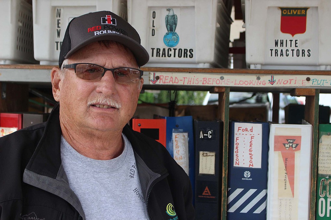 Tim Meister sells antique tractor manuals each year at the Tri-State Antique Engine and Tractor Show. The Meisters have amassed roughly 20,000 manuals and tractor literature since Tim’s father, Jim, started their collection almost 30 years ago. (The Commercial Review/Bailey Cline)