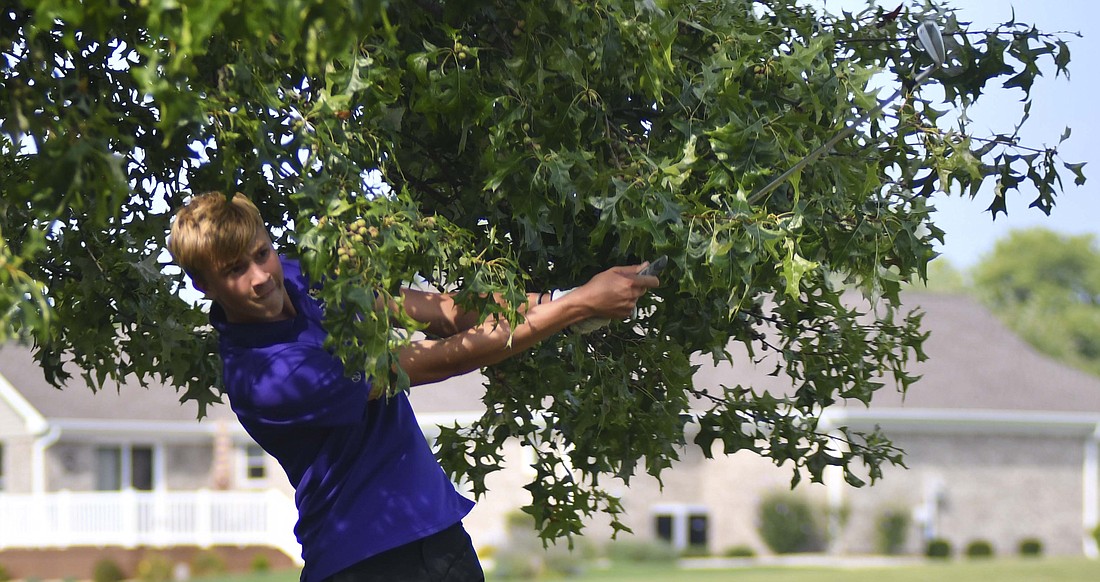 FRHS junior Eli Lennartz hits out from under a tree on the 14th hole at Portland Golf Club during Tuesday's match against Coldwater. The shot landed on the fringe where he chipped and sunk the put for par en route to a 41 in the round. (The Commercial Review/Andrew Balko)