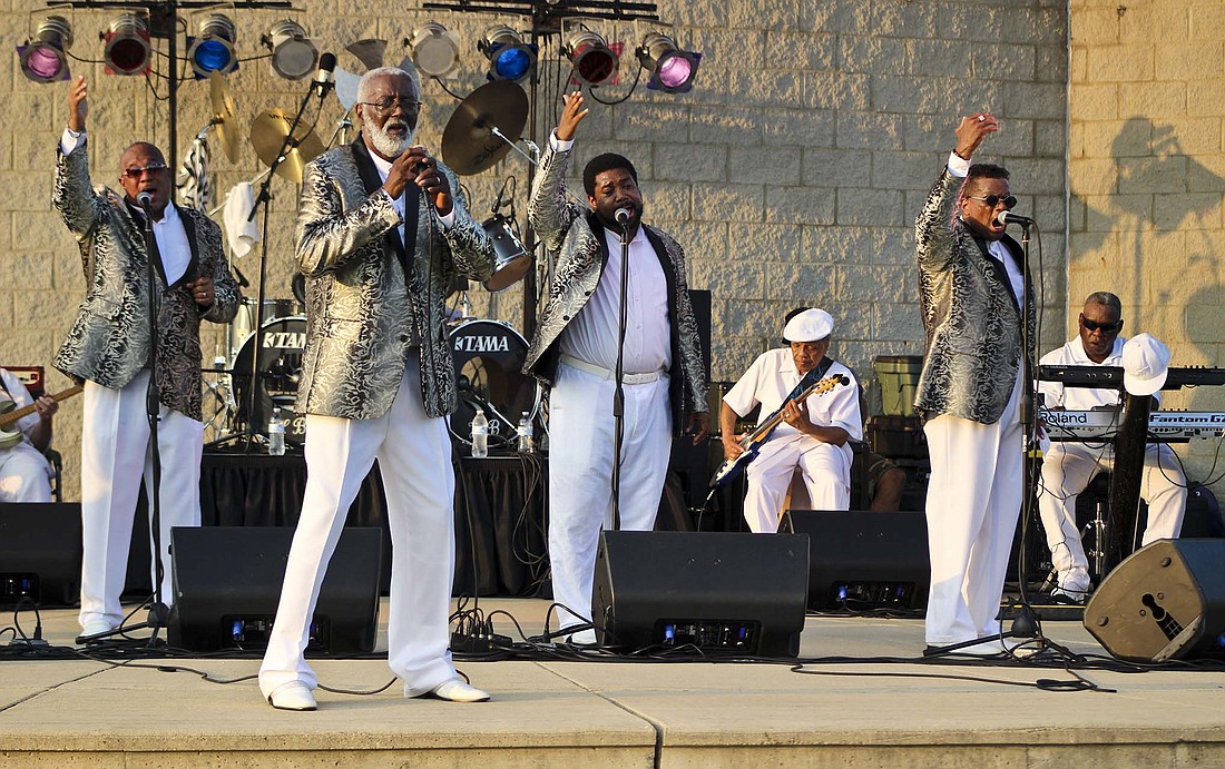 From left, The Motown Sounds of Touch performers Shayne Smith, Floyd Weatherspoon, Jelani Stokes and Arthur Stokes sing Thursday at Hudson Family Park in Portland. The group out of Dayton, Ohio, played hits from popular artists such as Earth, Wind and Fire, Marvin Gaye, Stevie Wonder, The Jackson 5 and The Temptations. (The Commercial Review/Bailey Cline)