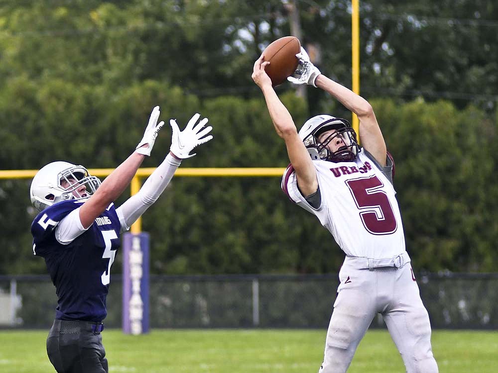 Urbana High School’s Brayden Cain picks off a pass in front of Austin Steinbrunner of Fort Recovery during the first quarter Friday. The Indians turned the ball over four times as they dropped to 0-2 for the first time since 2005 with a 28-20 loss to the Hillclimbers. (The Commercial Review/Ray Cooney)