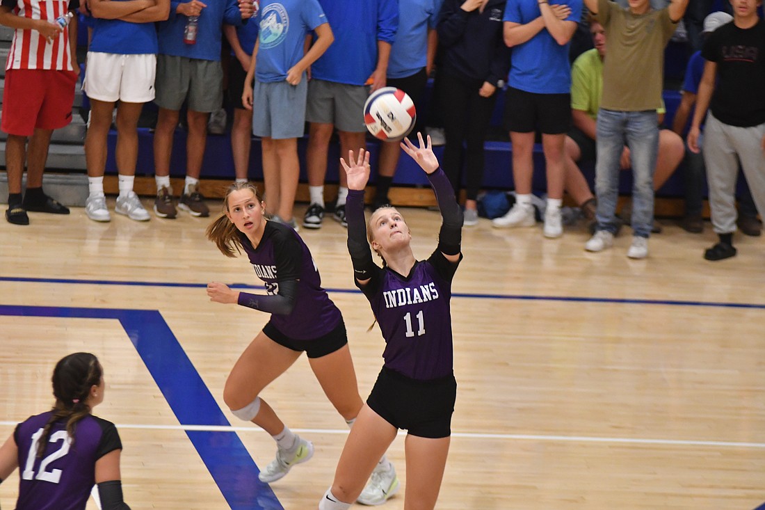 FRHS junior Kennedy Muhlenkamp sets a ball for a teammate during the Indians’ 25-22, 26-24, 25-21 win at Jay County on Tuesday. Seeing time on the floor as both a setter and a middle blocker, Muhlenkamp put together five kills, 16 assists, two aces and one dig for Fort Recovery. (The Commercial Review/Andrew Balko)