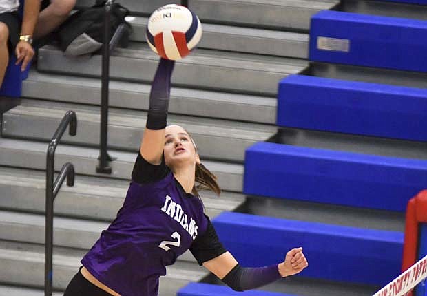 Mara Pearson of Fort Recovery swings at a ball near the net during the Indians’ three-set win over the Jay County Patriots on Tuesday. The Patriots had game point, but Pearson’s kill kept the Indians alive. She rattled off three more points to propel the Indians to the victory in the set, putting them in position to sweep. (The Commercial Review/Andrew Balko)