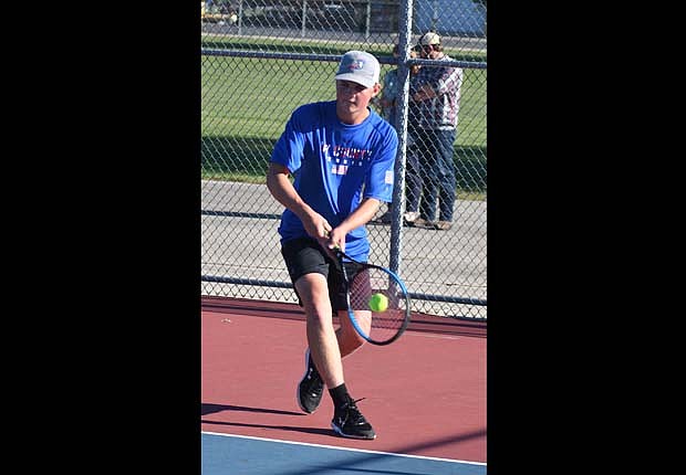 JCHS senior Abraham Dirksen hits a backhand shot during the No. 1 singles match against Ryan Sebastian on Thursday during the Patriots’ 3-2 loss to Marion. (The Commercial Review/Andrew Balko)