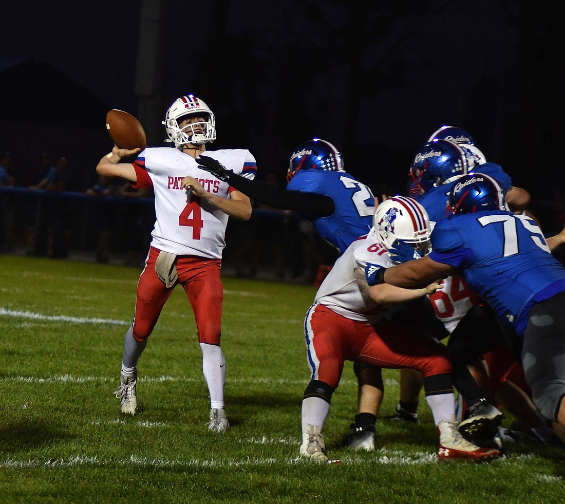 Sean Bailey, a junior at Jay County High School, throws the ball up for Justin DeHoff in the second half of Jay County's 43-12 win at Southern Wells on Friday night. Bailey connected with receivers on eight of 10 attempts for 224 yards and three touchdowns. (The Commercial Review/Andrew Balko)