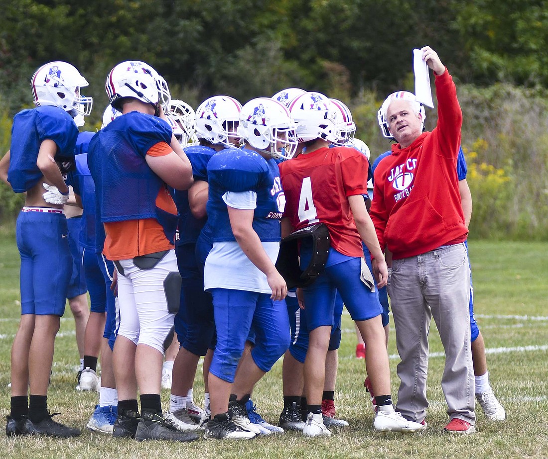 Jay County High School football coach Grant Zgunda shows the offense a play during practice Wednesday evening. The Patriots, who are 3-0 for the first time since 1985, were preparing for their biggest challenge of the season thus far as they will host the Class 1A No. 2 Adams Central Jets at 7 p.m. tonight. (The Commercial Review/Ray Cooney)