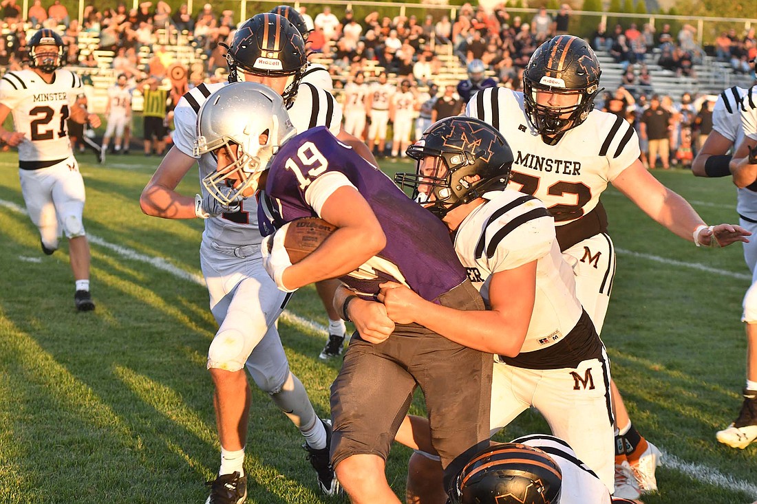 Alex Gaerke (19), a sophomore at Fort Recovery High School, gets wrapped up by Minster’s Kaleb Sharp during the Indians football game Friday. The Indians fell to the Wildcats 41-20 to drop to 0-4 and 0-2 in the Midwest Athletic Conference. (The Commercial Review/Andrew Balko)