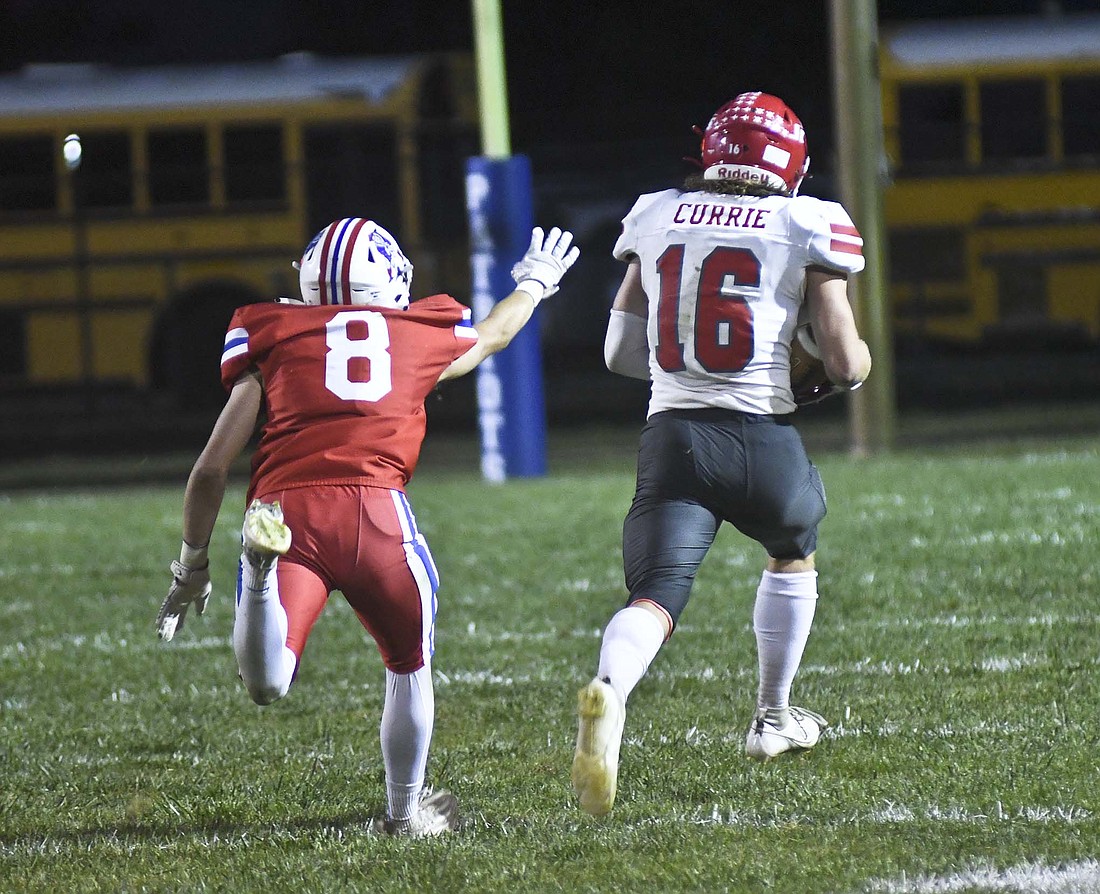 Trevor Currie of Adams Central runs just out of the reach of Jay County High School’s Carter Fugiett on a 57-yard touchdown pass from Jack Hamilton in the third quarter Friday night. The game was scoreless after the first quarter, but the Class 1A No. 2 Jets dominated the second and rolled to a 42-7 victory over the Patriots. (The Commercial Review/Ray Cooney)