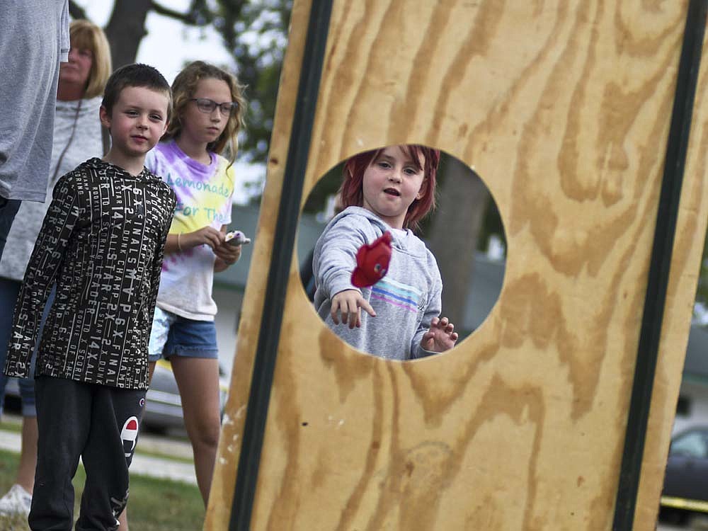 Ava Willoughy, 7, Dunkirk, tosses a bean bag fish toward the target at the "Feed the Croc" game during Saturday's Cancer Cruise hosted by Jay County Cancer Society at Jay County Fairgrounds. The event also included a cruise for cancer survivors and a luminary ceremony. (The Commercial Review/Ray Cooney)