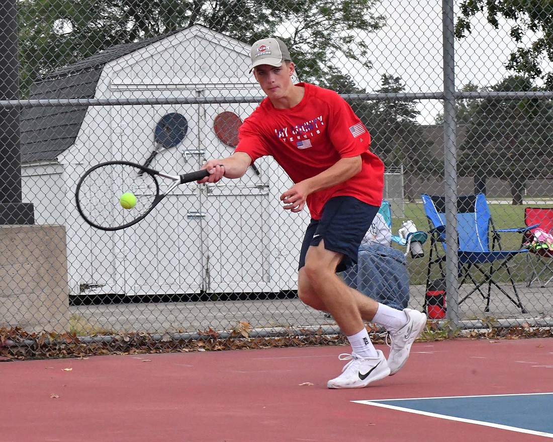 Jay County High School’s Eli Dirksen returns a serve with a forehand during the No. 2 singles match against Elwood’s Isaac Casas. Dirksen defeated Casas 6-3, 6-0 after falling to Wabash’s Eli Matteren earlier in the day. (The Commercial Review/Andrew Balko)