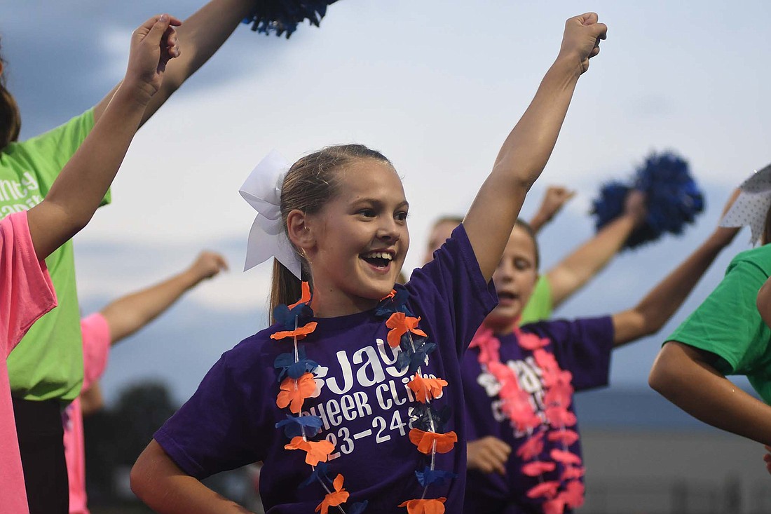 Sophie Warvel cheers on the sidelines during halftime of Friday night’s Jay County High School football game against Adams Central. She was one of 105 participants in the JCHS cheerleading clinic for kindergarten through sixth graders. (The Commercial Review/Ray Cooney)