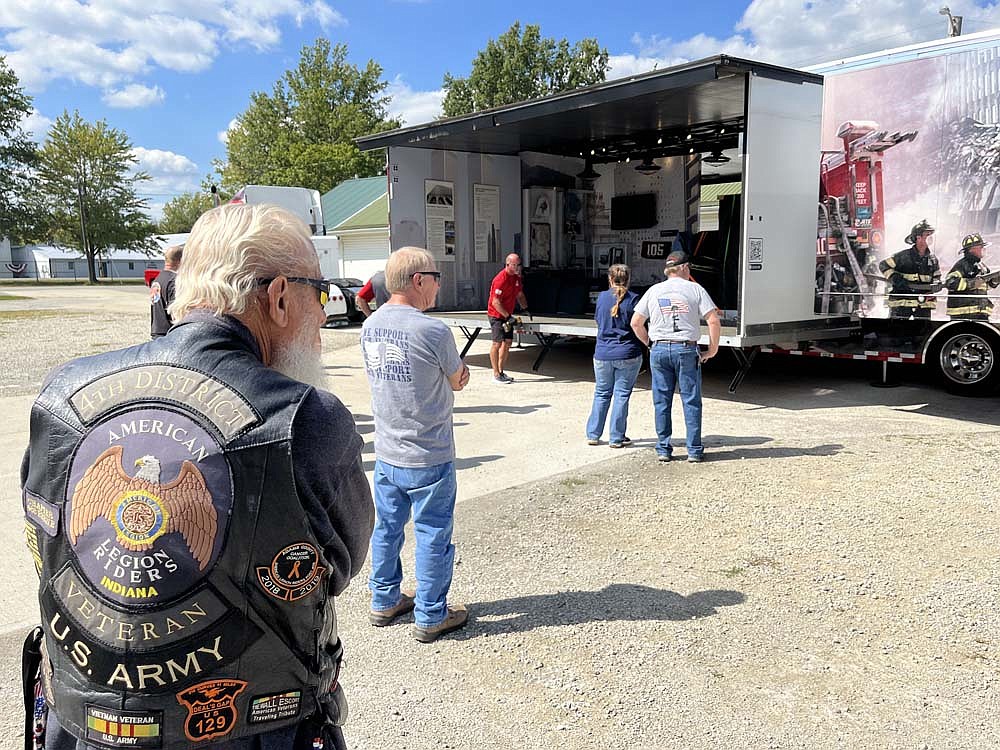 The Tunnel to Towers Foundation’s 9/11 NEVER FORGET Mobile Exhibit rolled into Jay County this afternoon. Pictured, volunteers work to set up the exhibit, which expands from a semi into a 1,100-square-foot space. The exhibit will be open Friday, Saturday and Sunday. (The Commercial Review/Ray Cooney)