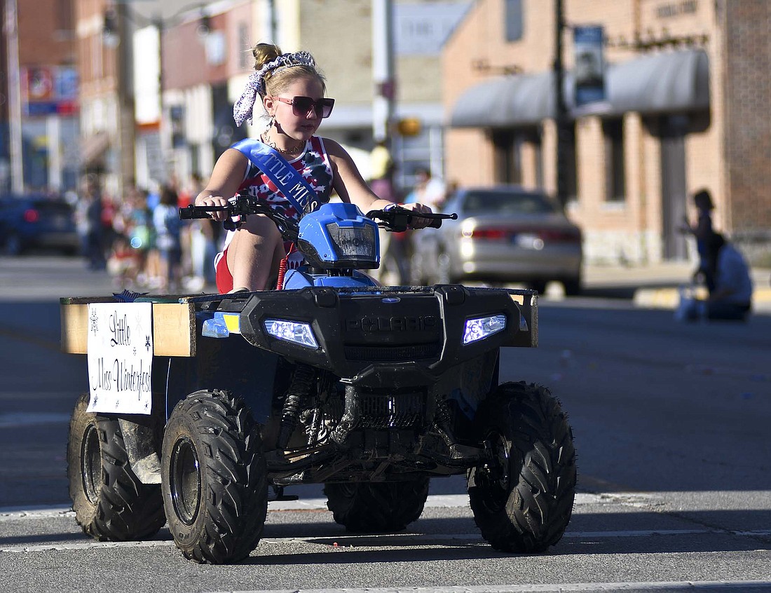 The homecoming festivities got started Friday night with the parade beginning at Jay County Fairgrounds through downtown Portland and finishing at Weiler-Wilson Park. Pictured above, 2022 Little Miss Winterfest Aria Barnett drives herself in the parade on a Polaris ATV, making the turn from Meridian Street onto Walnut Street on the modified parade route because of construction at the south end of the downtown area. (The Commercial Review/Ray Cooney)