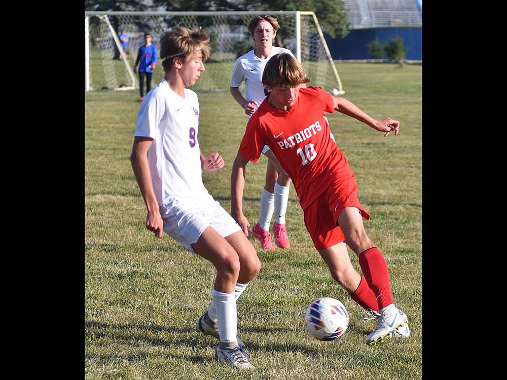 JCHS junior Cayden Buckland (10) makes a move to cross up Bellmont's Jake Hackman (9) as he dribbles upfield during the Patriots' 3-1 victory on Tuesday. Buckland took one shot at the goal that Bellmont goalie Parker Frietas saved. (The Commercial Review/Andrew Balko)