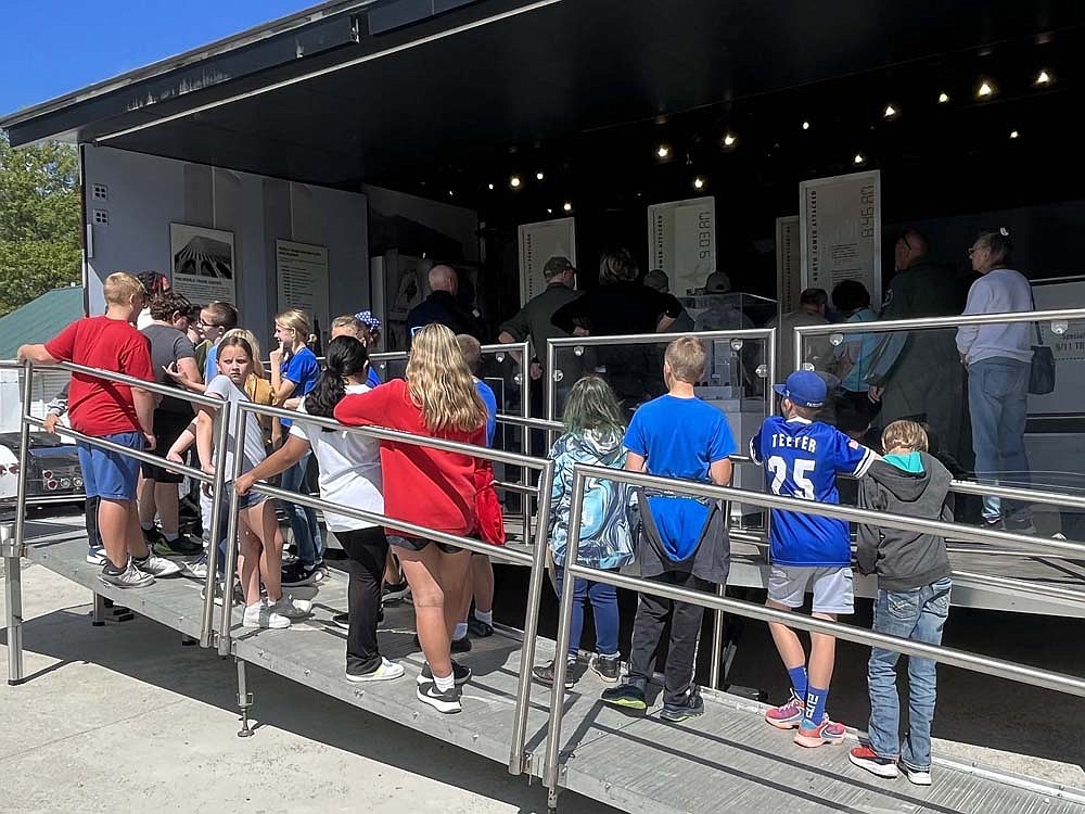 Students line up Friday afternoon to visit the 9/11 NEVER FORGET Mobile Exhibit at Jay County Fairgrounds. The exhibit will be open from 9 a.m. to 3 p.m. today and 10 a.m. to 4 p.m. Sunday at the fairgrounds. (The Commercial Review/Ray Cooney)