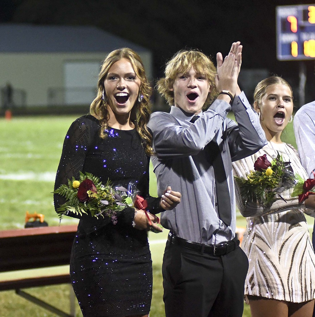 Molly Muhlenkamp, Jackson Edwards and Zion Beiswanger react Friday night after Muhlenkamp was announced as Jay County High School's homecoming queen during halftime of the Patriot football team's game against Bluffton. (The Commercial Review/Ray Cooney)