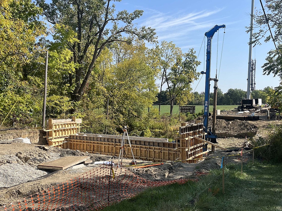 While work on the Meridian Street (U.S. 27) storm sewer project in Portland progressed to the north this week with the reopening of the street from the Salamonie River to Main Street, work is also continuing with the replacement of the Indiana 26 (Water Street) bridge over the Salamonie River on the eastern edge of the city. Pictured above is the status of the bridge work as of Wednesday. The Indiana Department of Transportation project is scheduled for completion in mid November. (The Commercial Review/Ray Cooney)