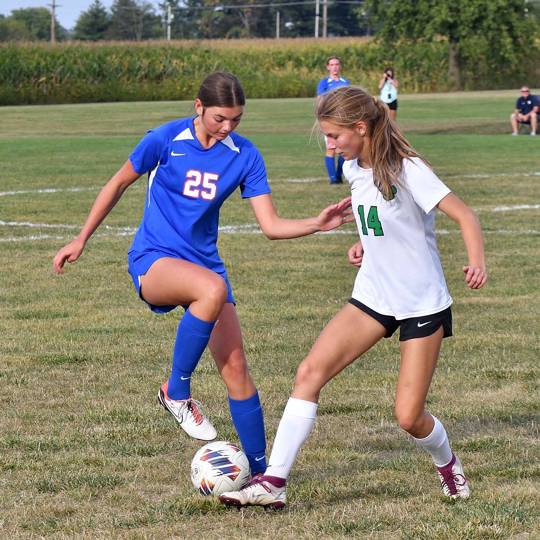 Jay County High School junior Meredith Dirkesn (25) pulls the ball back to keep possession as Yorktown’s Kylie Patton (14) tries to poke it away during the first half of the Patriots 3-1 loss on Thursday. (The Commercial Review/Andrew Balko)