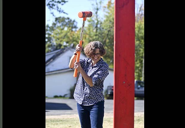 Anni McClung of Portland tries her hand at ringing the bell at the attraction hosted by Pete Vogler on Sunday at Jay County Historical Society’s Heritage Festival. (The Commercial Review/Ray Cooney)