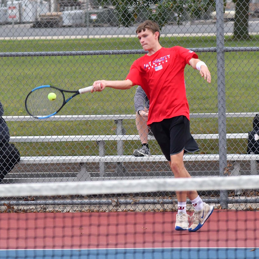 Isaac Miller of Jay County High School hits a forehand during the Patriots' 5-0 sweep of Winchester in the sectional opener on Thursday. Miller and Luke Muhlenkamp took down Winchester's No. 2 doubles duo 6-2, 6-0 in less than 50 minutes. (The Commercial Review/Andrew Balko)