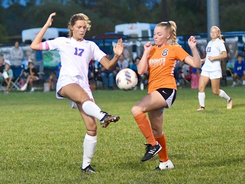 Jay County High School senior Molly Muhlenkamp tries to send the ball upfield against Emma Linville (8) of Hamilton Heights during the first half of Tuesday’s sectional semifinal game at Yorktown Sports Park. (Trailing the play is Natalie Marcum of the Huskies.) The first 34 minutes of the game were scoreless before Hamilton Heights broke through. JCHS went on to a 3-0 loss, marking the fifth consecutive year in which its season has come to an end against the Huskies. (The Commercial Review/Ray Cooney)