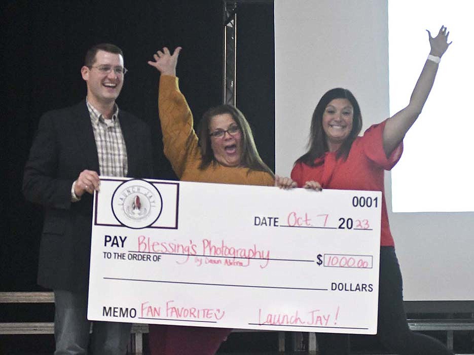 Blessings Photography was the fan favorite as well as the overall winner Saturday during the Launch Jay! business pitch competition in the Jay County Junior/Senior High School auditorium. Pictured is Blessings owner Dawn Alicea (center) with Travis Richards of Jay County Development Corporation and Tabby Sprunger of Jay County Chamber of Commerce. (The Commercial Review/Ray Cooney)