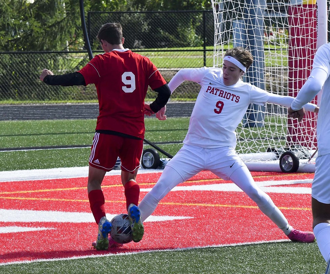 JCHS senior Brayden Collins (right) lunges at the ball to disrupt MississinewaÕs Karsyn Bougher (left) during the second half of the IHSAA Class 2A Sectional 24 championship on Saturday. The Patriots fell to the host of the tournament 2-1 in overtime. (The Commerical Review/Andrew Balko)