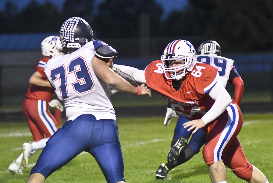 Jay County High School senior offensive lineman Ryne Goldsworthy keeps a hand on Charlie Riddle of Heritage as quarterback Shawn Bailey rolls to the opposite side of the field during the first half Friday night. A 28-6 loss for JCHS kept it from its first winning regular season since 2016 as it dropped five of its last six games following a 3-0 start. (The Commercial Review/Ray Cooney)