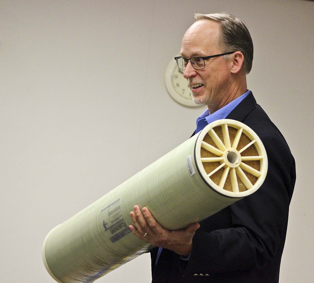 Rob Shoaf, owner of Shoaf Consulting, shows Fort Recovery Village Council members a reverse osmosis membrane element sized to the village’s treatment plant. (The Commercial Review/Bailey Cline)
