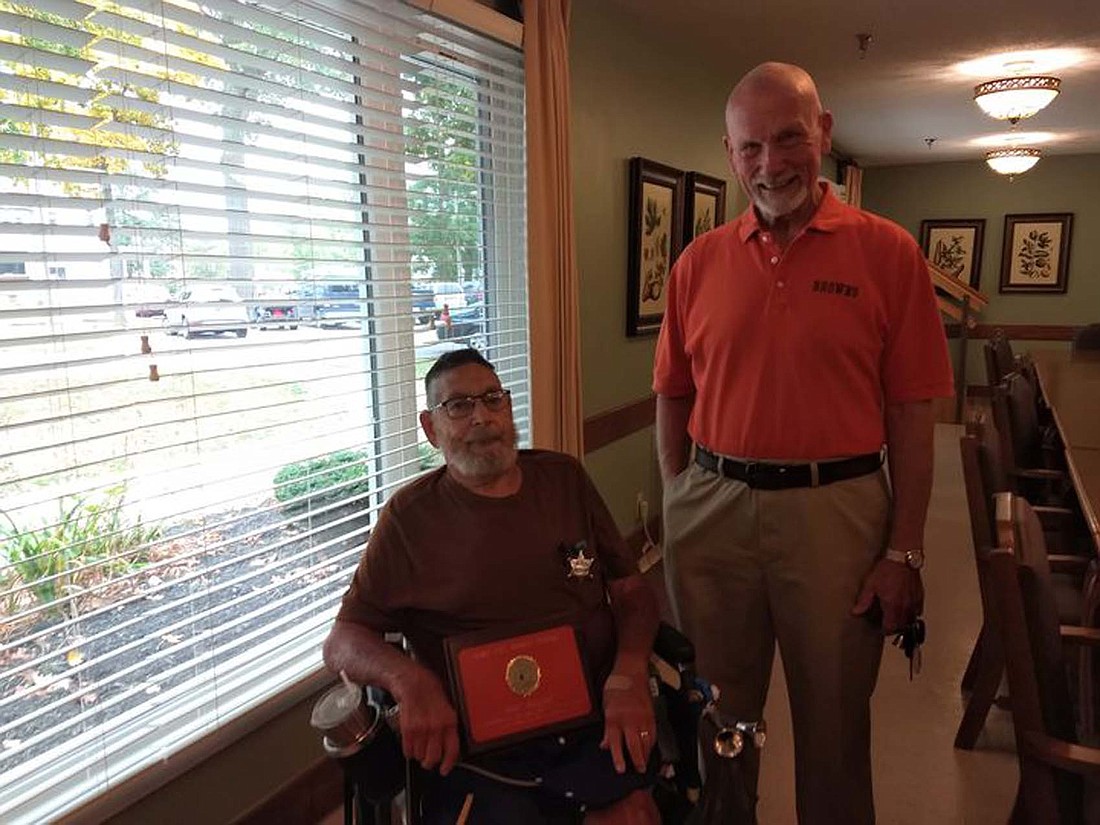 Dave Johnson poses with a plaque given to him on Oct. 14 by Union City Browns Backers president Scott Stahl for Johnson’s continuous support. (Photo provided)