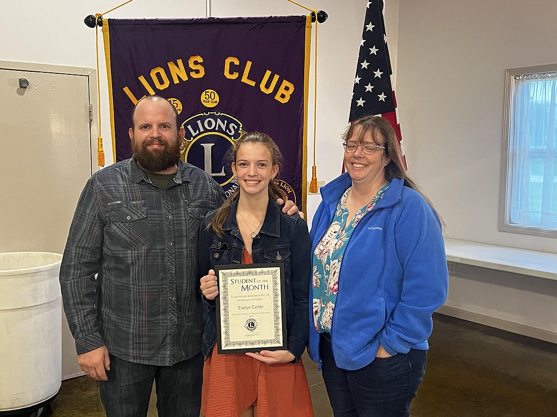 Evelyn Carter, pictured above in the center with parents Jeb and Angel Carter, was honored by Portland Lions Club as September Student of the Month. She’s an eighth grader at Jay County Junior-Senior High School. (Photo provided)