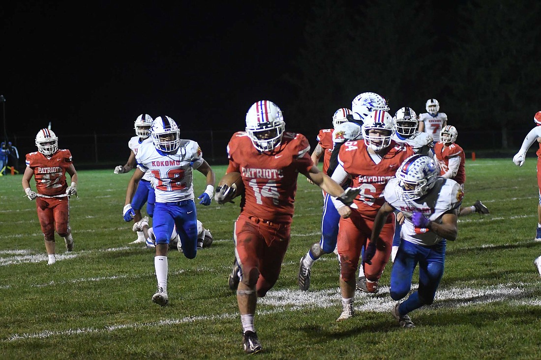 Bryce Wenk of Jay County High School carries the ball during the first half of the Patriots’ 21-14 sectional loss Friday the Class 4A No. 9 Kokomo Wildkats. Wenk picked up 100 yards on 16 carries and also had a 65-yard fumble return for a TD. (The Commercial Review/Ray Cooney)