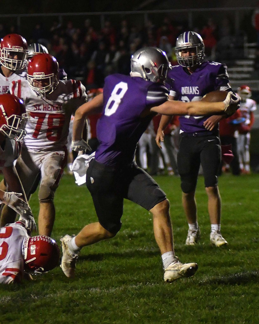 Fort Recovery High School senior Reece Guggenbiller reaches the football over the goal line late in the first half for the first score of the game for the Indians on Friday night. Guggenbiller had 41 total yards in the final game of his career as Fort Recovery fell 28-27 to St. Henry in overtime. (The Commercial Review/Andrew Balko)