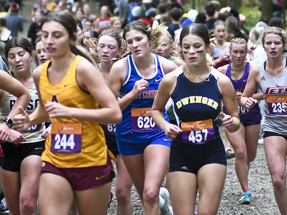 Jay County High School sophomore Alexis Sibray (center) runs amidst a mass of athletes nearing the mid-point of Saturday's regional cross country race hosted by New Haven at The Plex in Fort Wayne. Sibray placed 112th in the field of 246 runners. (The Commercial Review/Ray Cooney)