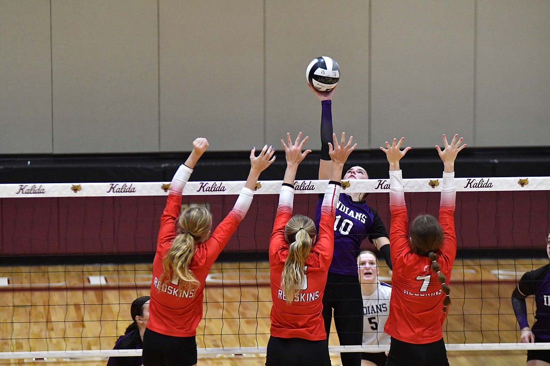 Fort Recovery senior Teigan Fortkamp goes up to hit against three St. Henry defenders during Monday’s district opener. (The Commercial Review/Andrew Balko)