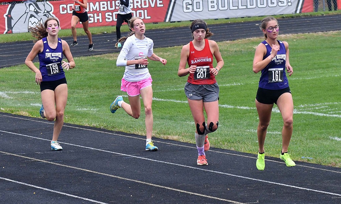 FRHS girls cross country runners Ellie Will (161) and Joelle Kaup (159) come down the final stretch at the district meet at Columbus Grove on Saturday. Will held her position to finish 12th and Kaup found a a burst of energy to pass Ariyah Pfenning (287) of New Knoxville and Cady Doladson (middle left) of St. JohnÕs. (The Commercial Review/Andrew Balko)