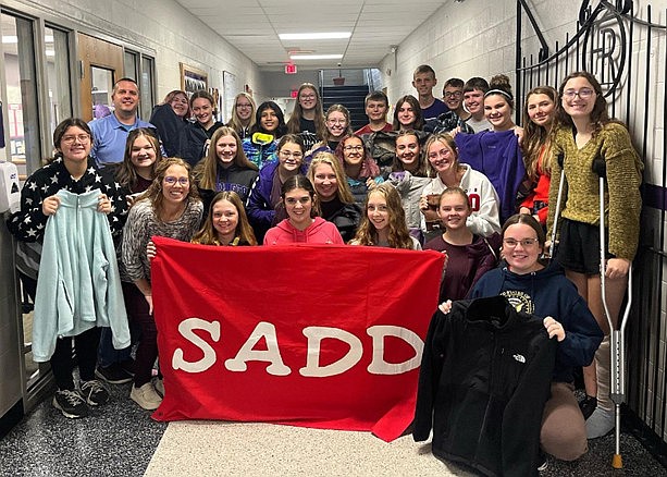 Fort Recovery High School SADD Club recently held a winter coat and hat drive, with all donations sent to Our Home Family Resource Center in Celina, Ohio. Pictured is Our Home Family Resource Center director, Kevin Draiss, SADD Club members, and the SADD advisor, Mrs. Reinhard. Our Home Family Resource Center distributed more than 500 winter coats that were collected throughout Mercer County during their Winter Warmth Day on Oct. 21. (Photo provided)