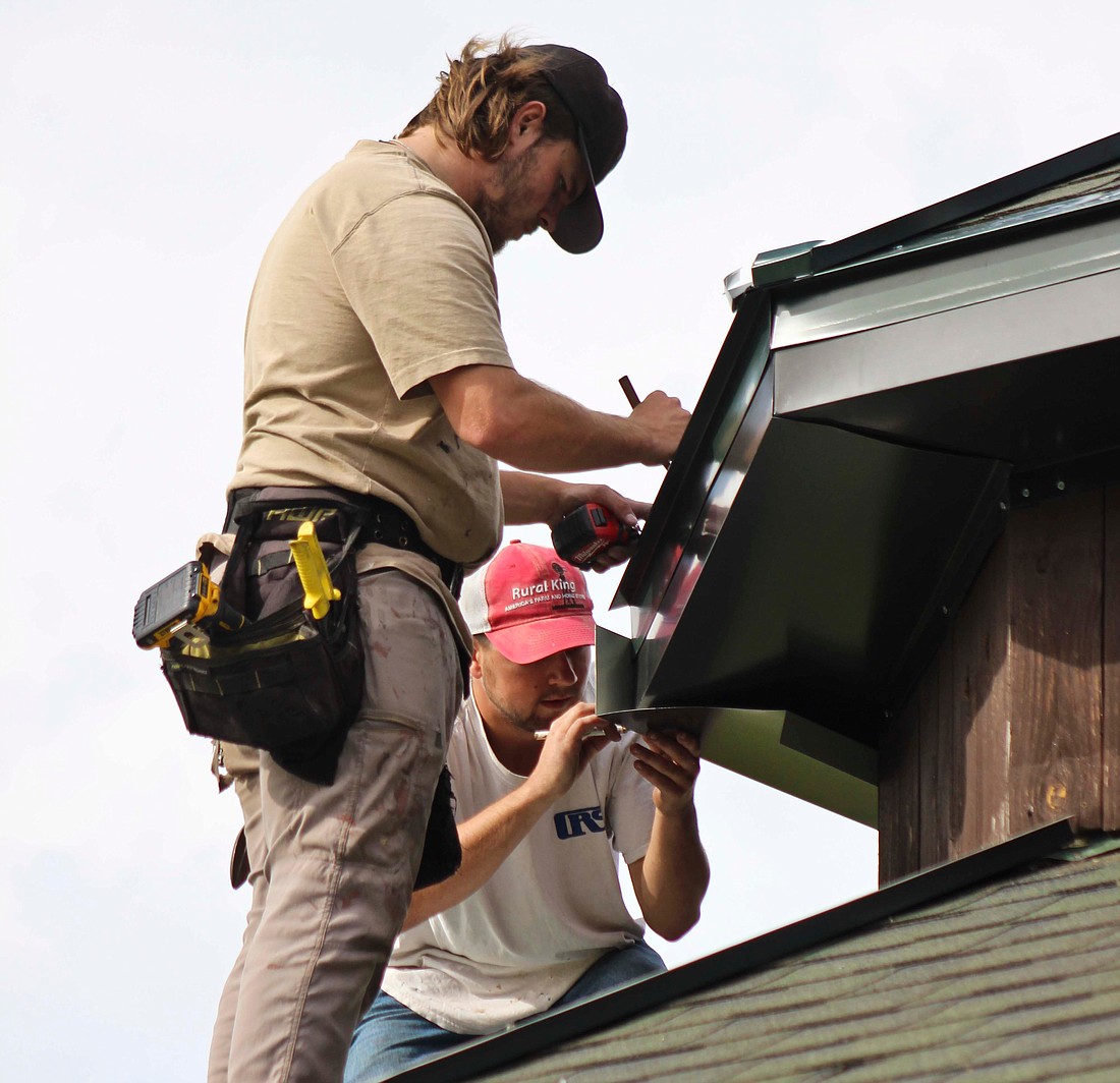 Construction workers install metal roofing on a gazebo Thursday at Hudson Family Park in Portland. Roof replacements have been an ongoing project for Portland Park Board throughout the city’s park system. (The Commercial Review/Bailey Cline)