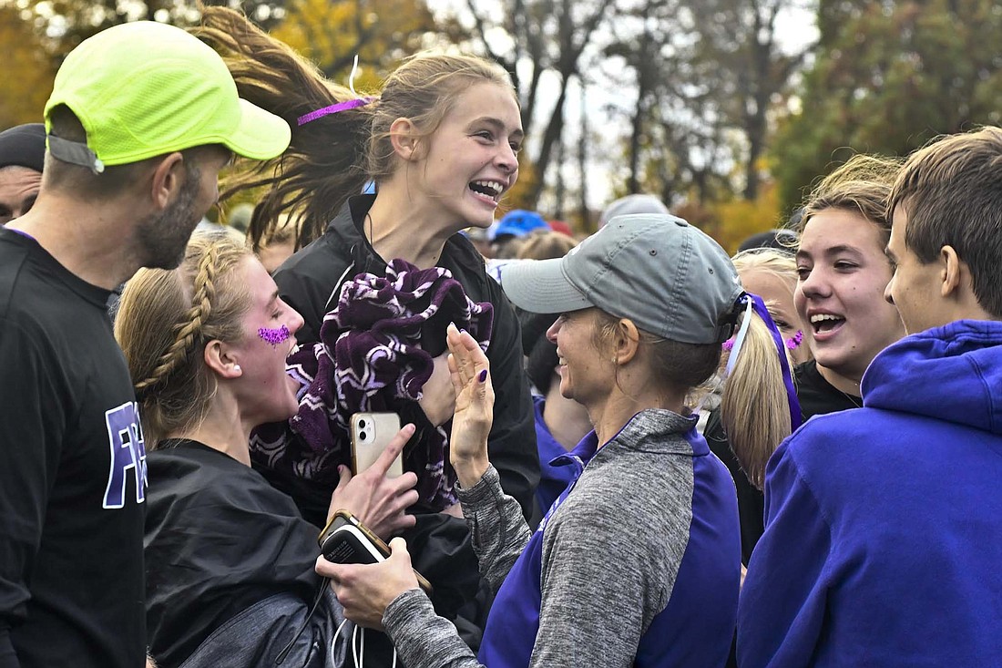 Members of the Fort Recovery High School girls cross country team celebrate as Natalie Brunswick (left) delivers the news that it officially finished sixth at the regional meet held at Hedges-Boyer Park to punch its ticket to state. The Indians had to wait 75 minutes after their race to learn they earned a state berth. For more on the meet, see page "Stress test" in sports. (The Commercial Review/Andrew Balko)